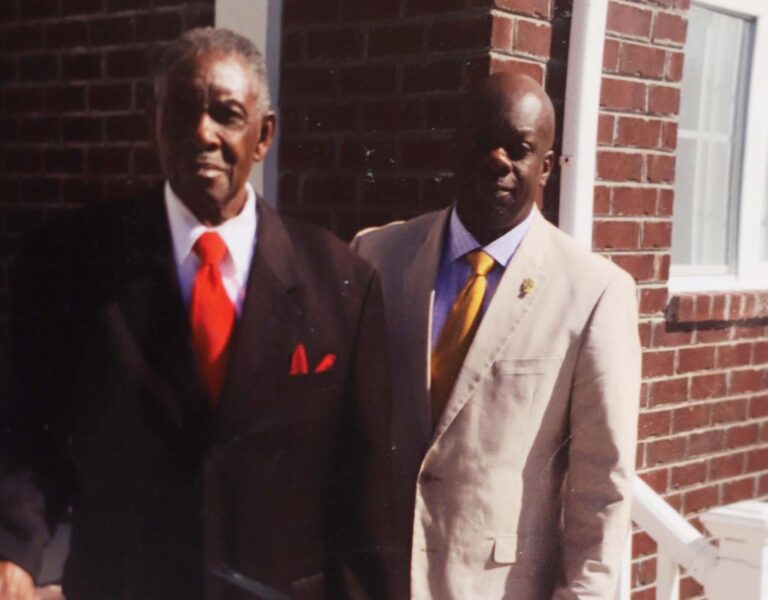 Father and son standing in front of a church